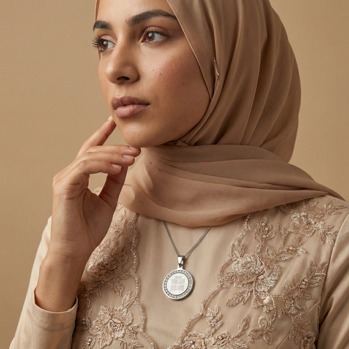 Woman wearing a gold pendant necklace